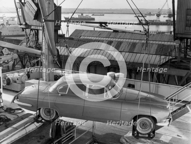 1962 Jaguar MkX being loaded on to Saxonia ship at Southampton docks for export. Creator: Unknown.