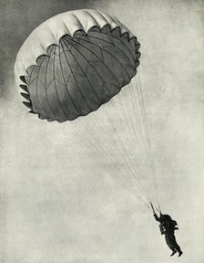 Airman using a parachute during the Second World War, 1941. Creator: Charles Brown.