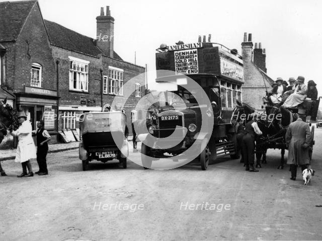 1920's Thornycroft J bus in busy street scene. Creator: Unknown.