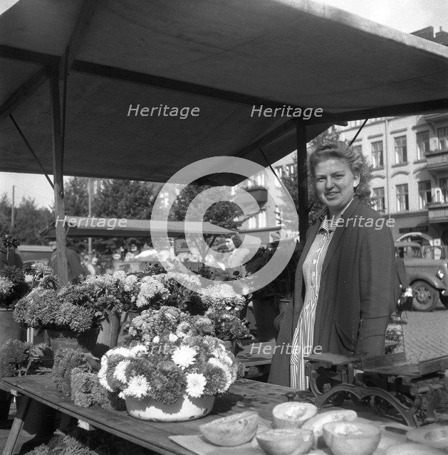 Woman on her flower stall in the market, Malmö, Sweden, 1947. Artist: Otto Ohm