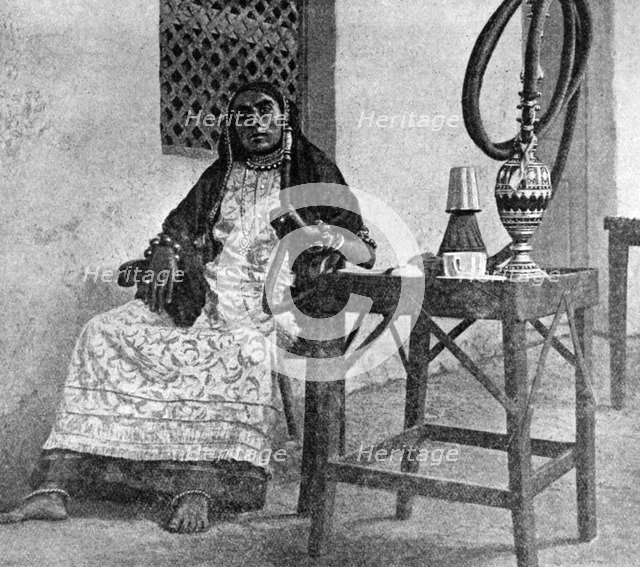 Somali woman smoking a hookah, Aden, 1922. Artist: Unknown