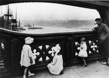 People watching the Thames from Tower Bridge, City of London, c1930. Artist: George Davison Reid
