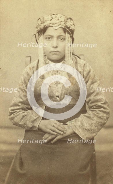Three-quarters length portrait of a woman, seated, facing front, between 1870 and 1886. Creator: Unknown.