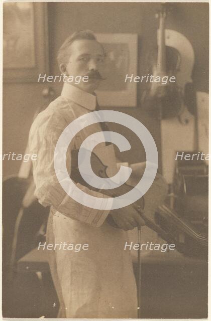 Portrait of a Violin Maker in Studio, 1895-1943. Creator: Louis Fleckenstein.