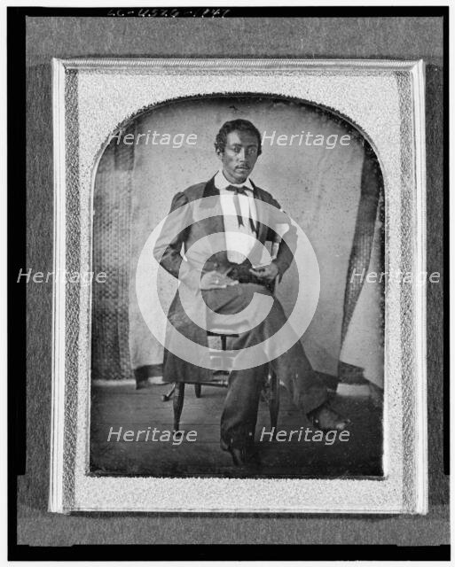 R. McGill, full-length portrait, seated in chair, facing front, with..., between 1840 and 1860. Creator: Unknown.