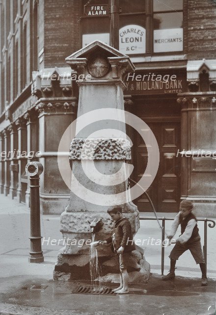 Children drawing water from the Aldgate pump, London, August 1908. Artist: Unknown.