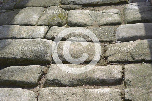 Remains of a Roman road next to the Valmardon Gate, paved with granite slabs, Toledo, Spain, 2022. Creator: LTL.