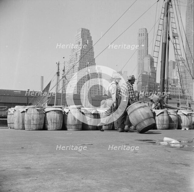 Barrels of fish on the docks at Fulton fish market ready to be shipped to retailers, New York, 1943. Creator: Gordon Parks.