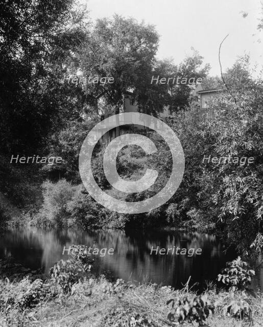 House above river, probably the Huron River, Ypsilanti, Mich., between 1900 and 1910. Creator: Unknown.