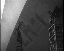 An R 38 Airship Body Being Painted in a Hangar, 1921. Creator: British Pathe Ltd.