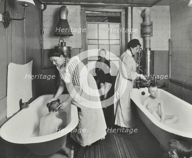 Attendants bathing boys at the Central Street Cleansing Station, London, 1914. Artist: Unknown.