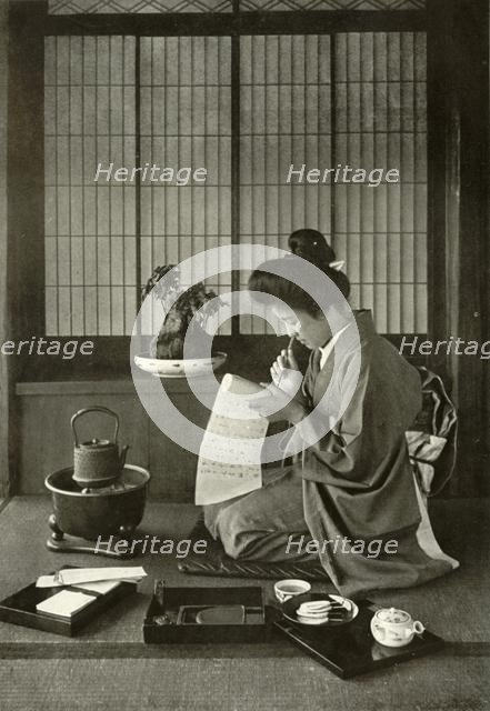 'Writing A Letter', 1910. Creator: Herbert Ponting.