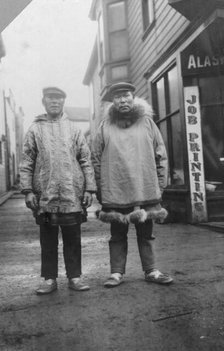 Eskimos outside shops, on a commercial street in Nome, between c1900 and 1916. Creator: Unknown.