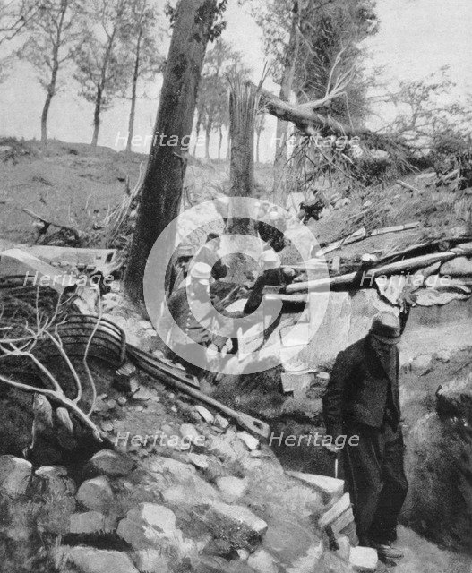 French soldiers going through a trench after a heavy German bombardment, World War I, 1915. Artist: Unknown