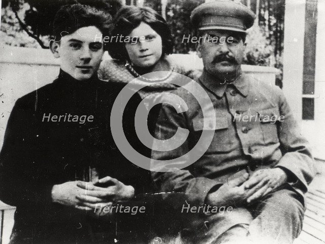 Soviet leader Josef Stalin with his son Vasily and daughter Svetlana, 1930s.  Artist: Pyotr Otsup.