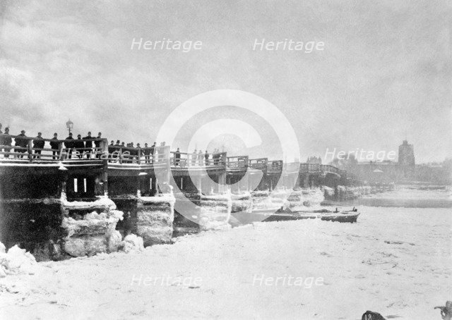 People looking at the frozen Thames from Old Putney Bridge looking South, Putney, London, c1881. Artist: Unknown