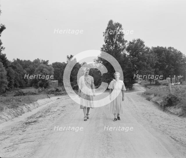 Women walking down the road to see a sick neighbor, Person County, North Carolina, 1939. Creator: Dorothea Lange.
