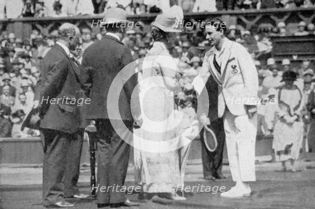 Jean Borotra receives his medal from Queen Mary on centre court, 1926. Artist: London News Agency