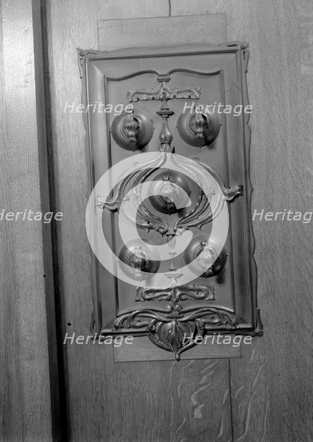 A bronze switch plate in the John Rylands Library, University of Manchester, 1942.   Creator: GB Wood.