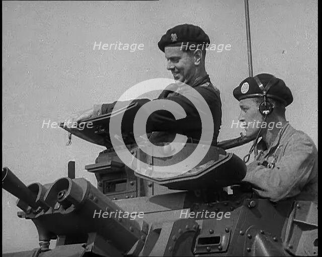Two British Tank Operators Looking Out of a Tank Turret, 1940. Creator: British Pathe Ltd.