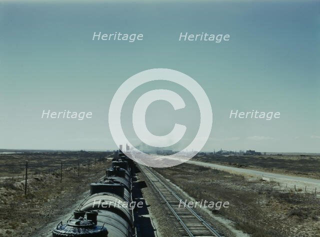 West bound Santa Fe R.R. freight train stopping for water, Tolar, New Mexico, 1943. Creator: Jack Delano.