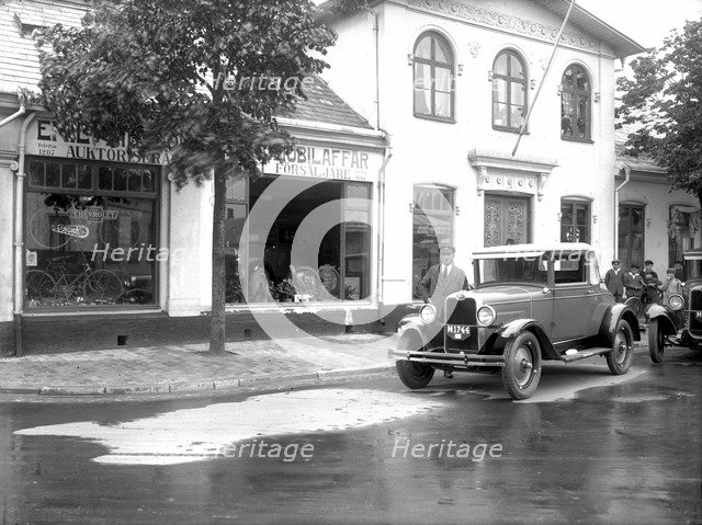 Ford car and driver outside a car company, Landskrona, Sweden, 1925. Artist: Unknown