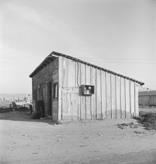 Cabin which rents for ten dollars a month in Arkansawyer's auto camp, Greenfield, CA, 1939. Creator: Dorothea Lange.
