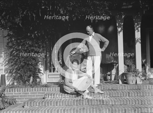 King, Hamilton, Mr. and Mrs., seated on the steps of their home, 1932 or 1933. Creator: Arnold Genthe.