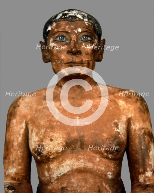 Sitting scribe in polychromed limestone, height 53 cm. belonging to the 5th Dynasty.