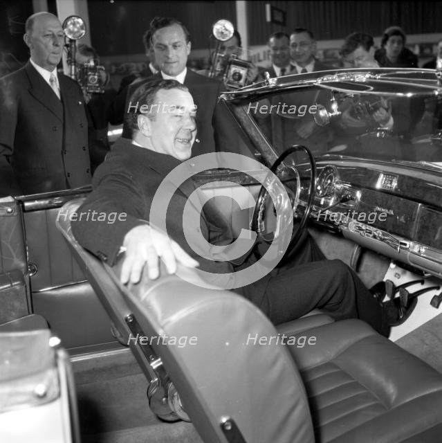 Prince Bertil tests a convertible Mercedes Benz at the car showroom in Stockholm, 1954.
 Creator: Unknown.