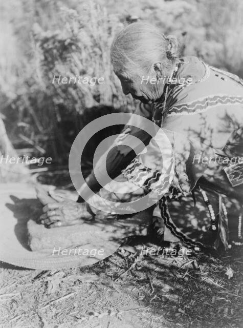 Grinding wokas-Klamath, c1923. Creator: Edward Sheriff Curtis.