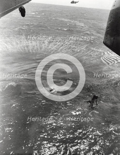 Navy frogmen swim to spacecraft to begin retrieval, Pacific Ocean, 1963. Creator: NASA.