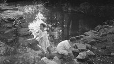 Kennerley, Richard and Morley, playing by a pond, 1912 or 1913. Creator: Arnold Genthe.
