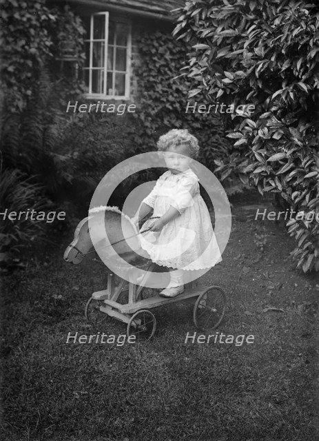 Child on a wooden horse, c1896-c1920. Artist: A Newton