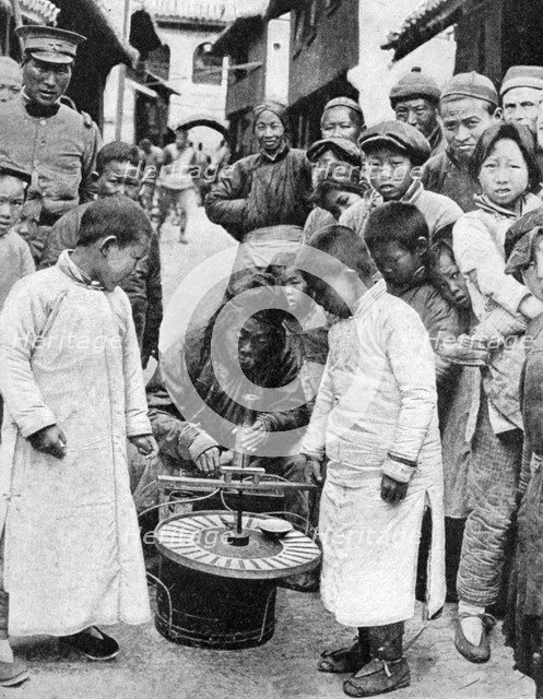 Street gambling, China, 1922. Artist: BT Prideaux