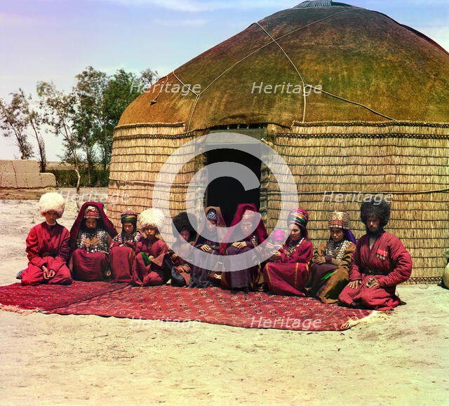 Group of eleven adults and children, seated on a rug, in front of a yurt, between 1905 and 1915. Creator: Sergey Mikhaylovich Prokudin-Gorsky.