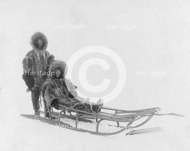 Couple on dog sled, between c1900 and 1927. Creator: Lomen Brothers.
