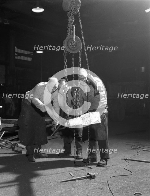 Three workers from Edgar Allen's handle a red hot billet, Sheffield, South Yorkshire, 1963. Artist: Michael Walters