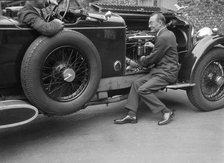 Geoffrey Baker inspecting the engine of a Minerva car. Artist: Bill Brunell.