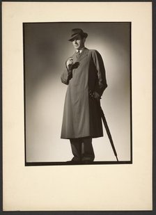 Man modeling trench coat, about 1943. Creator: Gunther Krampf.