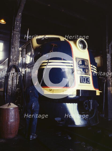 Washing one of the Santa Fe R.R. 54 hundred horse power diesel freight...,Argentine, Kansas, 1943. Creator: Jack Delano.