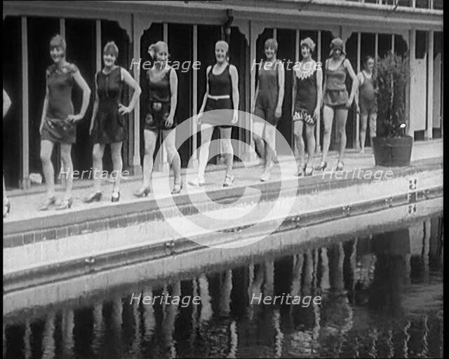 A Group of Young Female Civilians Wearing Short Swimsuits and Heeled Shoes Emerging from..., 1920. Creator: British Pathe Ltd.