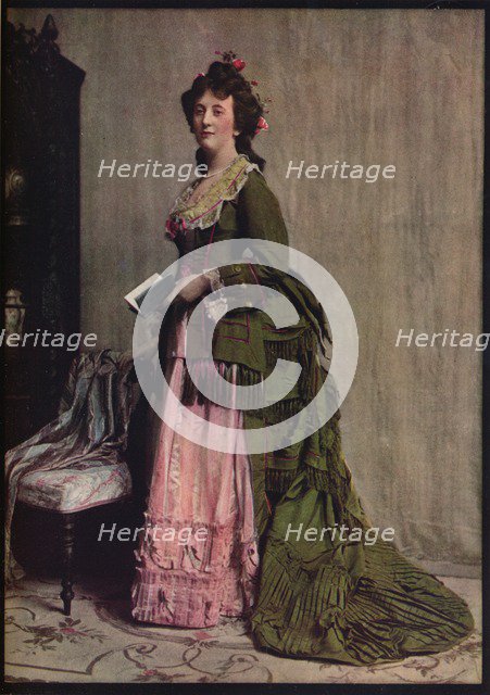 'An afternoon dress of green and pink silk. Very typical of the modes between 1868 and 1878', c1913. Artist: Unknown.