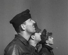 A Group of Male Pilots Watching Aircraft in the Sky, 1943-1944. Creator: British Pathe Ltd.