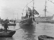 After launch of 'Shamrock IV' at Gosport with H.M.S. Victory in the background, May 1914. Creator: Kirk & Sons of Cowes.