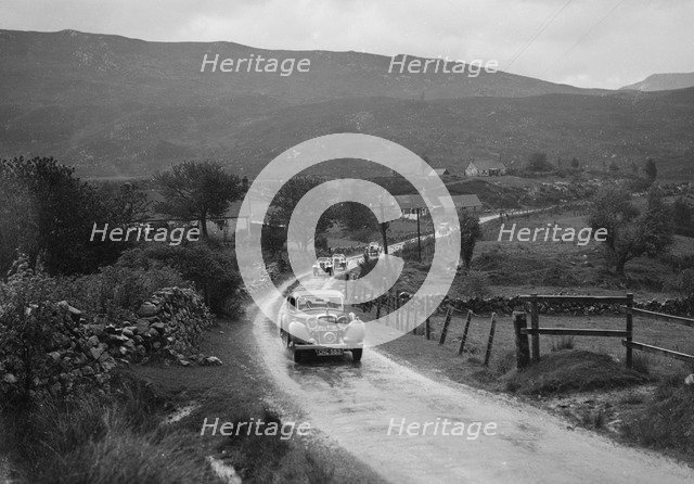 Singer Le Mans of WJB Richardson and SS Jaguar saloon of W Hetherington, RSAC Scottish Rally, 1936. Artist: Bill Brunell.