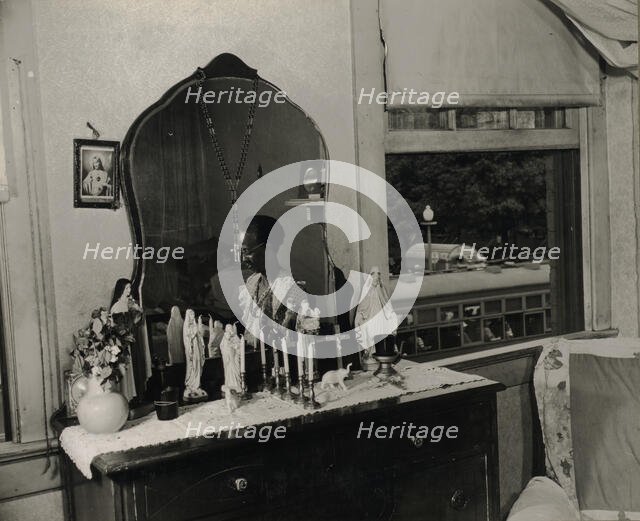 Dresser in the bedroom of Mrs. Ella Watson, a government charwoman, Washington, D.C., 1942. Creator: Gordon Parks.