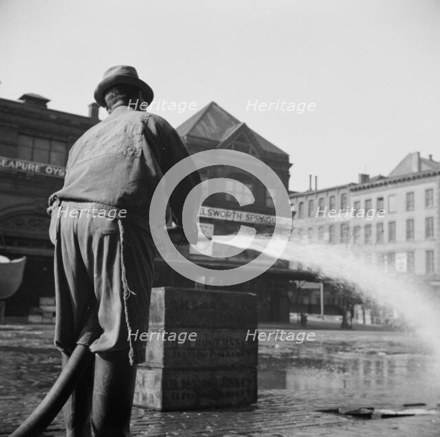 Workmen from the sanitary department flushing the street in front of the Fulton..., New York, 1943. Creator: Gordon Parks.