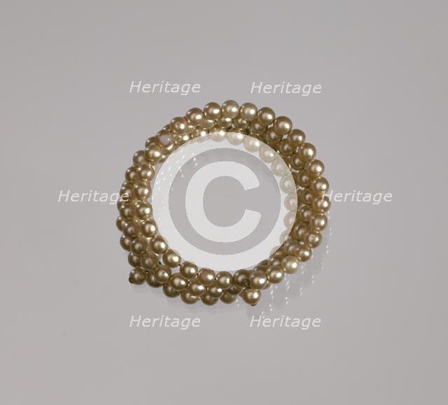 Gold pearl coil bracelet from Mae's Millinery Shop, 1941-1994. Creator: Unknown.