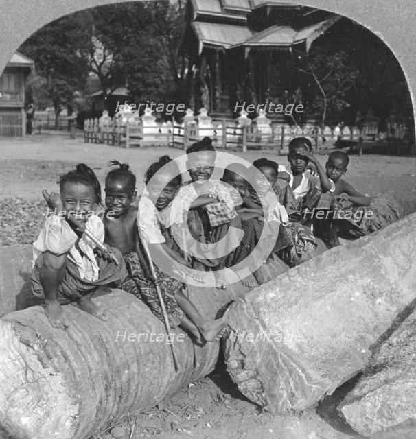 Burmese children sitting on a palm log, Burma, 1908. Artist: Stereo Travel Co